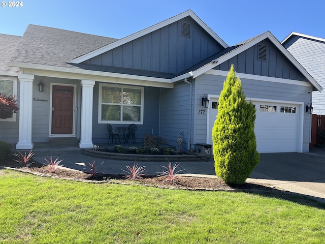 view of front of property with a garage and a front yard