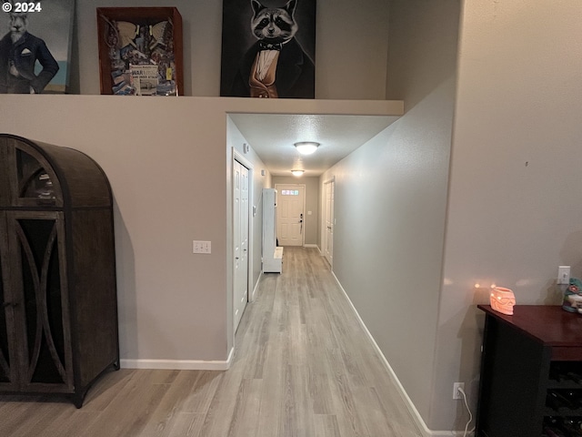 corridor with light wood-type flooring