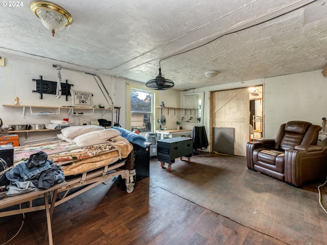 interior space featuring dark wood-type flooring and a barn door