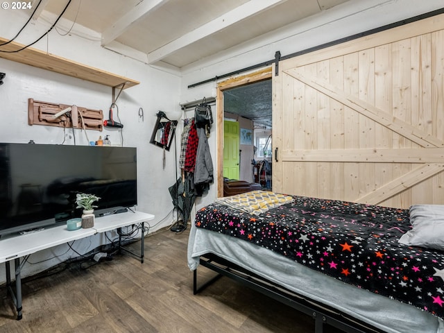 bedroom featuring a barn door and wood-type flooring