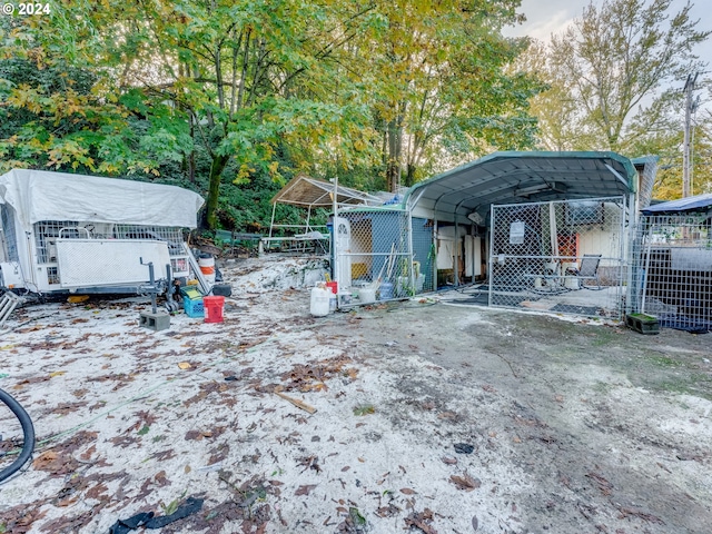 exterior space with a storage unit and a carport