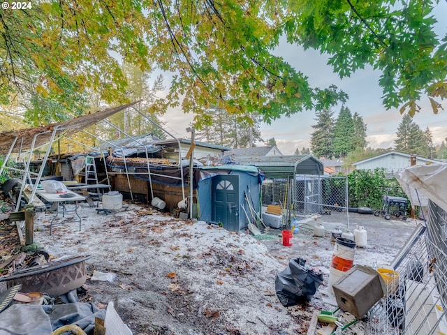 yard at dusk featuring a storage shed