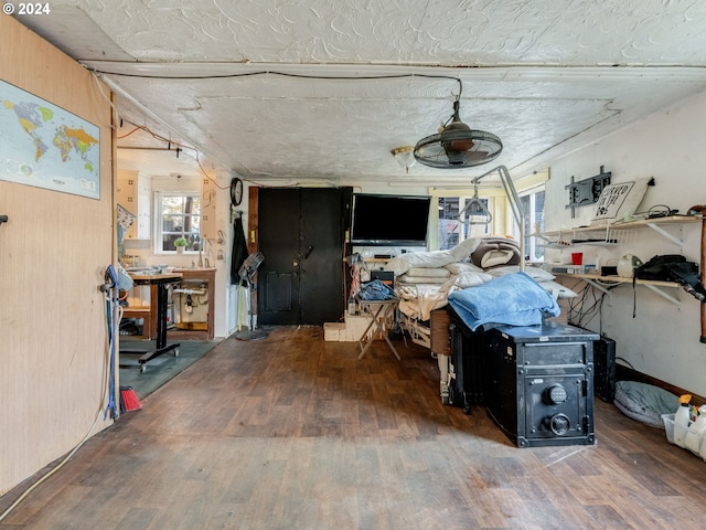 interior space featuring wood walls, a workshop area, and hardwood / wood-style floors