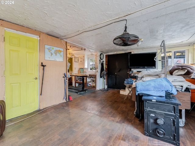 interior space featuring wooden walls, dark hardwood / wood-style floors, and plenty of natural light