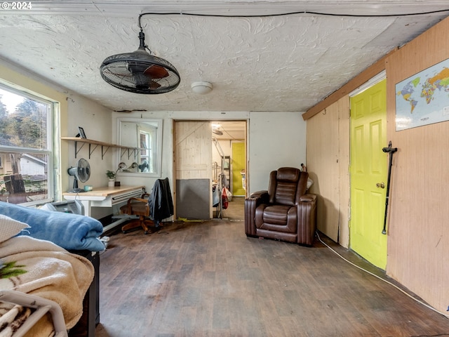 living room with wooden walls and dark hardwood / wood-style floors