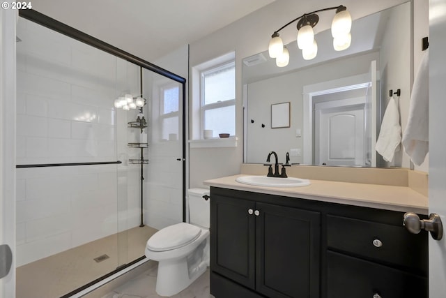 bathroom with vanity, toilet, and a shower with shower door