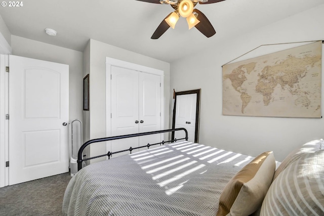 bedroom with ceiling fan, dark carpet, and a closet