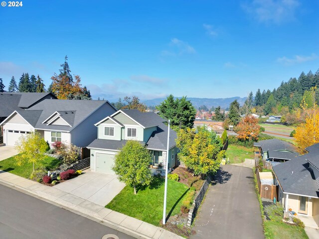 view of front of house with a garage and a front lawn