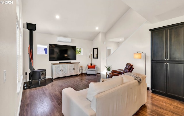 living room featuring an AC wall unit, lofted ceiling, dark hardwood / wood-style flooring, and a wood stove