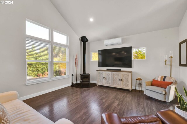 living room with dark hardwood / wood-style flooring, a wall mounted air conditioner, high vaulted ceiling, and a wood stove