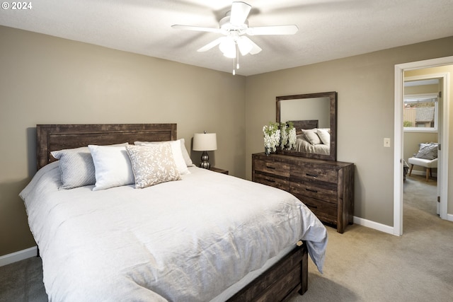 bedroom with ceiling fan, carpet, and a textured ceiling