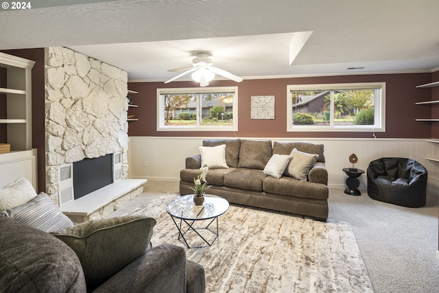 carpeted living room featuring a textured ceiling, ceiling fan, built in features, and crown molding