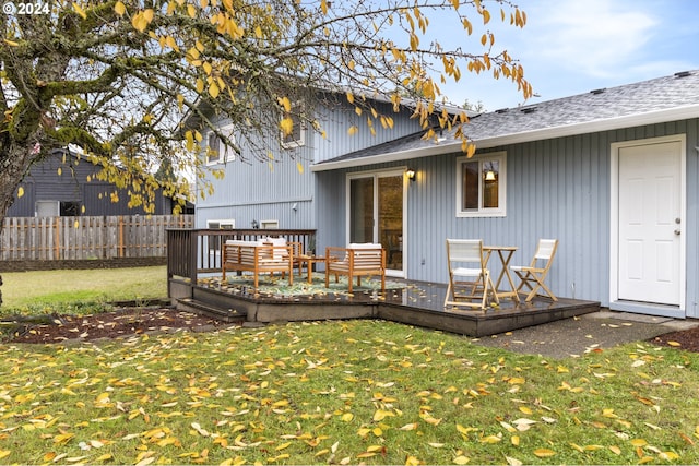 rear view of house featuring a yard and a wooden deck