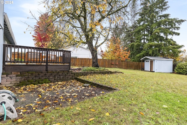 view of yard with a shed and a wooden deck