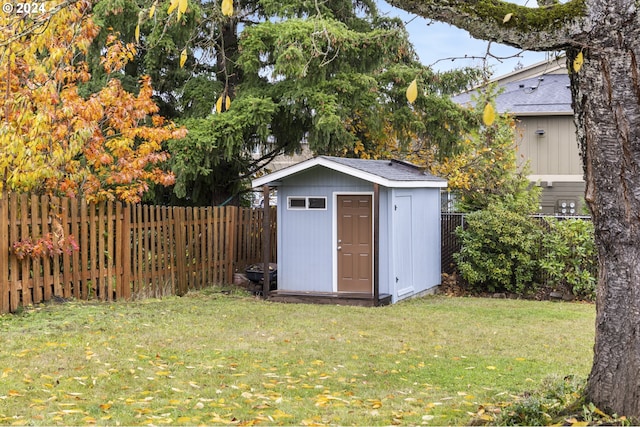 view of outbuilding featuring a lawn