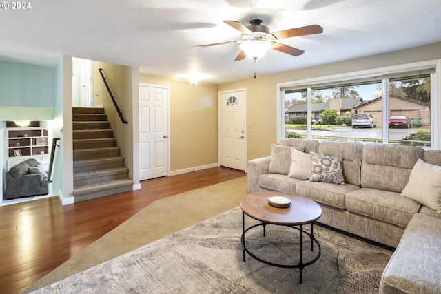 living room featuring ceiling fan and wood-type flooring