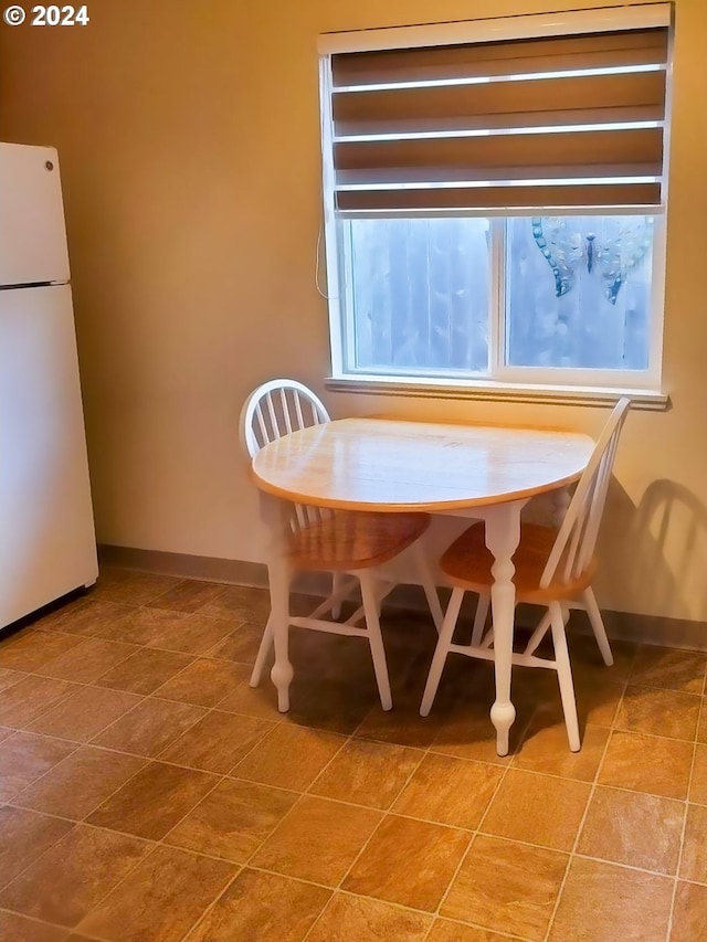 unfurnished dining area featuring baseboards