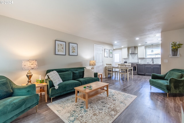 living room with dark wood-style floors and recessed lighting