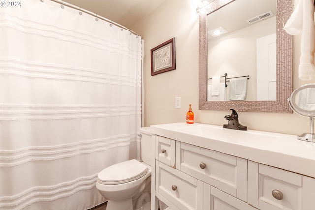 bathroom with visible vents, toilet, and vanity