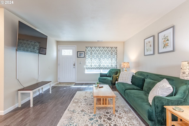 living room featuring visible vents, baseboards, and dark wood finished floors