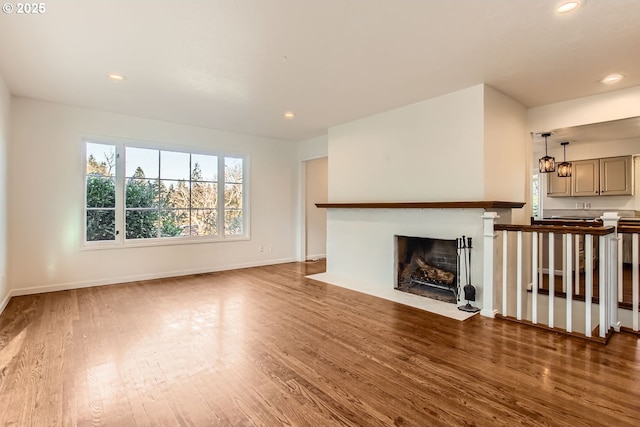 unfurnished living room with dark hardwood / wood-style flooring