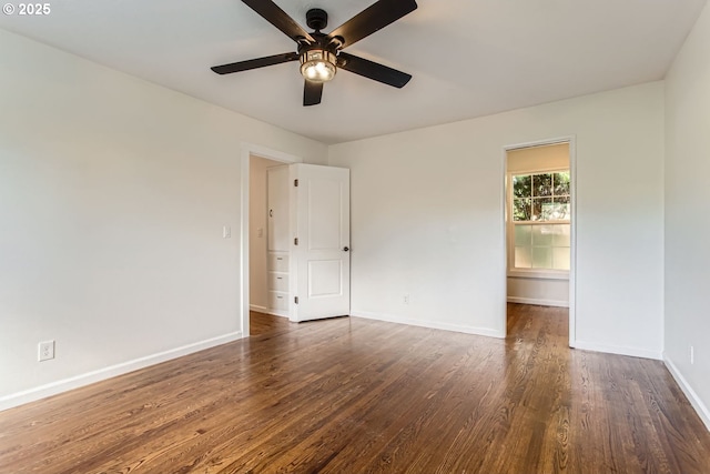 empty room featuring dark hardwood / wood-style flooring and ceiling fan