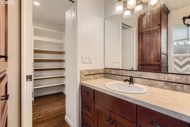 bathroom with hardwood / wood-style floors and vanity