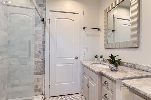 bathroom featuring vanity and a shower with shower door