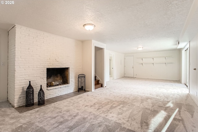 unfurnished living room with a fireplace, carpet, and a textured ceiling