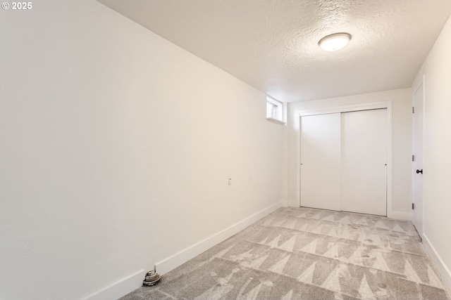 carpeted spare room featuring a textured ceiling