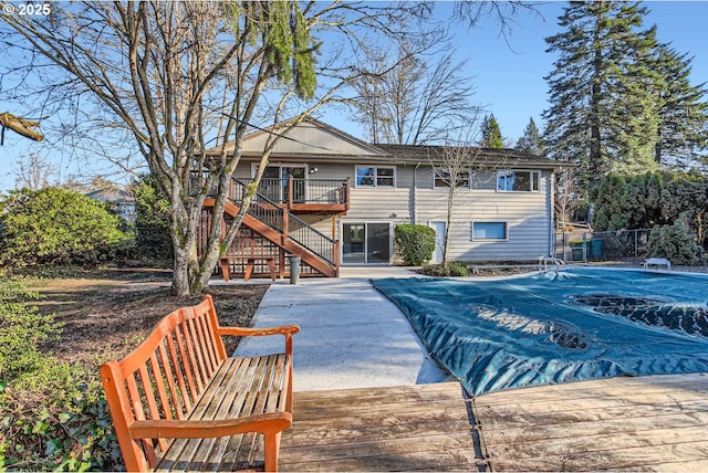 rear view of property with a patio and a pool side deck