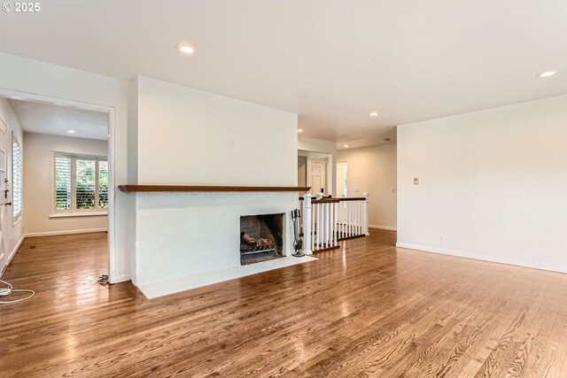 unfurnished living room featuring hardwood / wood-style flooring