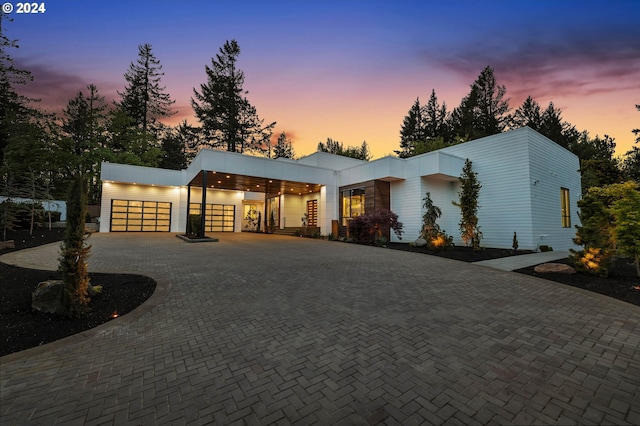 view of front of home featuring decorative driveway and an attached garage