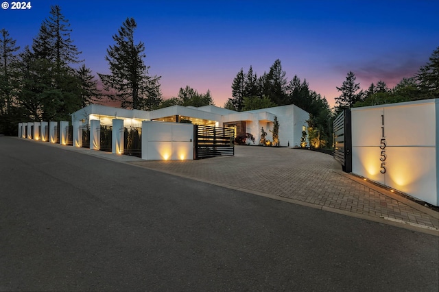 contemporary home with fence and a gate