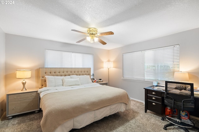 carpeted bedroom with a textured ceiling and ceiling fan