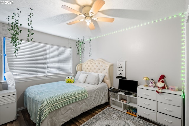 bedroom featuring a textured ceiling, ceiling fan, and dark wood-type flooring