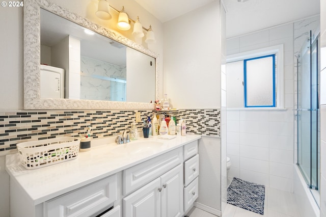 full bathroom with tile patterned floors, vanity, tasteful backsplash, and toilet