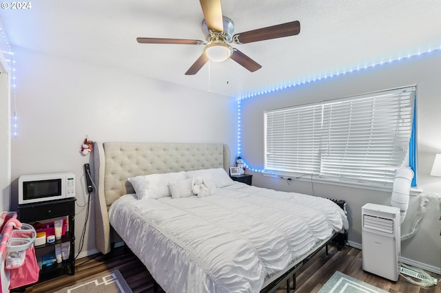 bedroom with ceiling fan and dark hardwood / wood-style floors