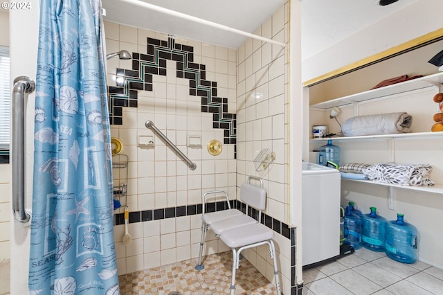 bathroom featuring washer / dryer and a shower with curtain