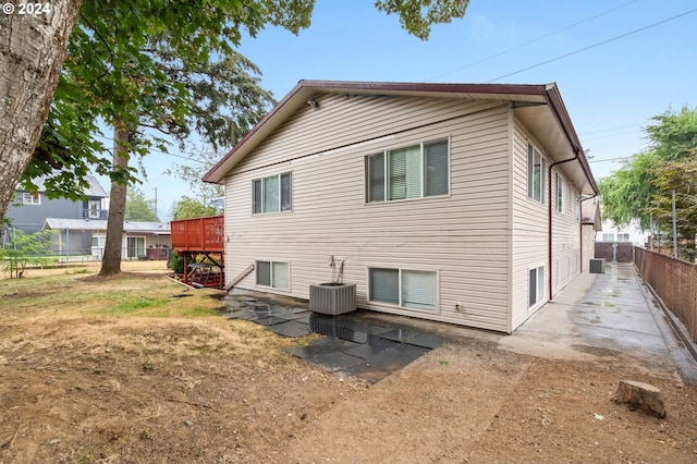 back of house featuring a deck and central AC