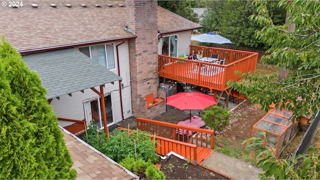 rear view of house featuring a deck