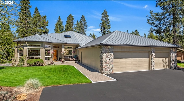 view of front of home with a front lawn and a garage