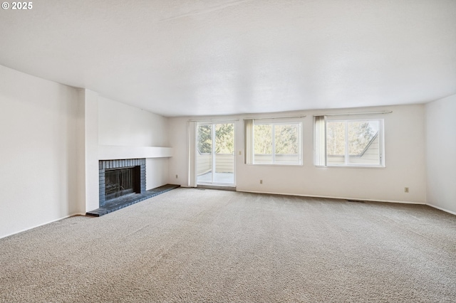 unfurnished living room featuring carpet and a fireplace