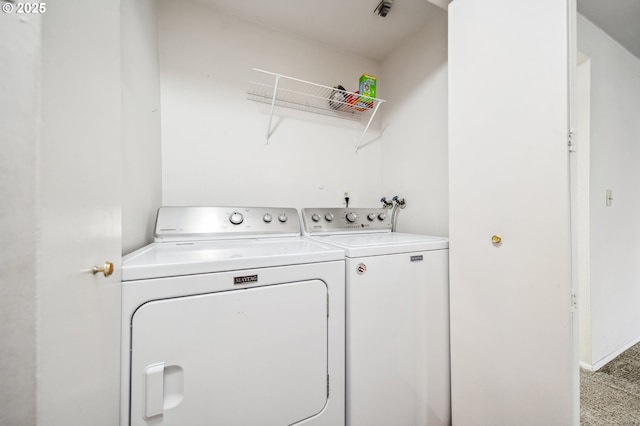 washroom with washer and dryer and carpet flooring