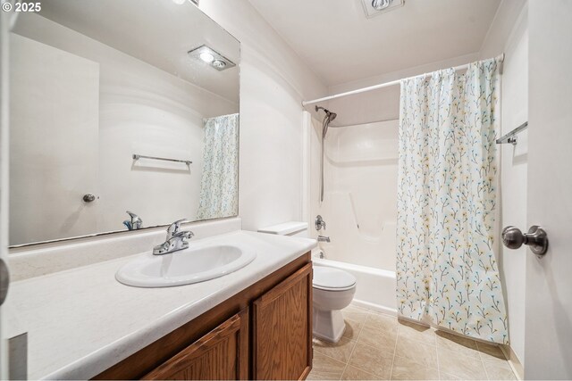 full bathroom featuring vanity, shower / bath combo, tile patterned floors, and toilet