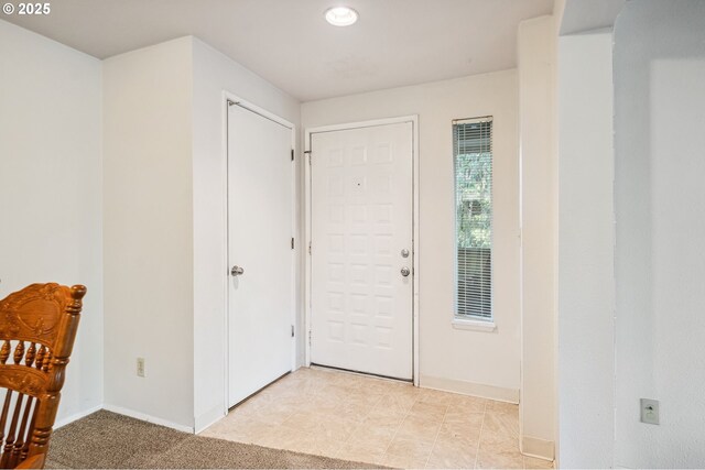 unfurnished living room featuring carpet floors and a brick fireplace