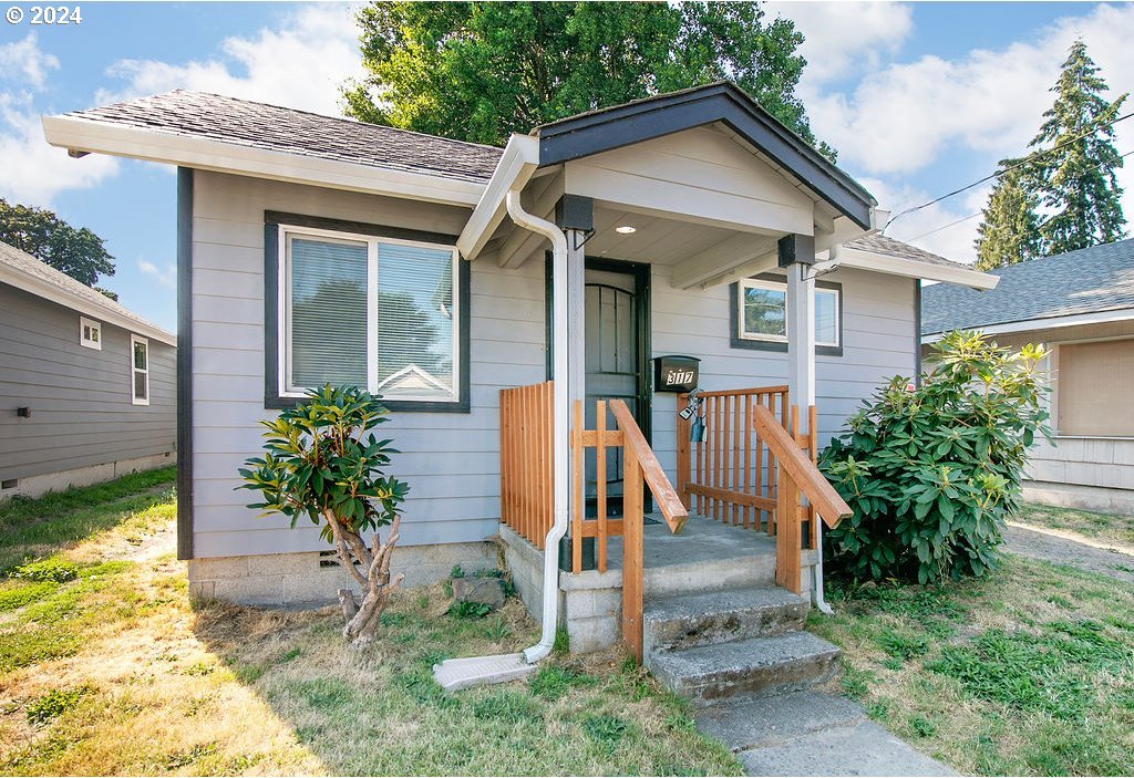 bungalow-style house with a shingled roof