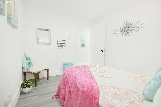 bedroom featuring light wood-style flooring and baseboards