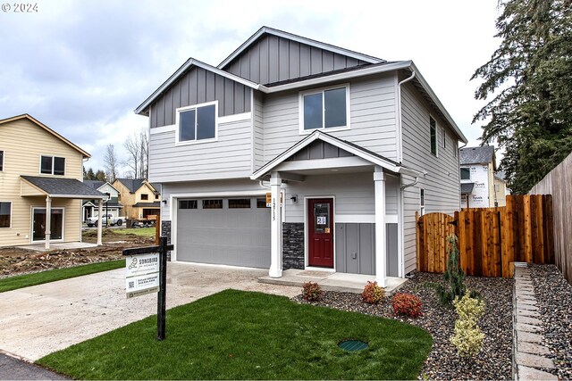 craftsman house featuring a garage and a front lawn