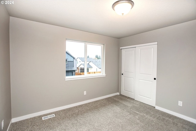 unfurnished bedroom with carpet and a closet